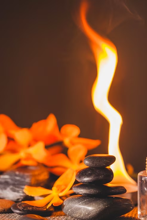 Spa stones with flowers and candle fire